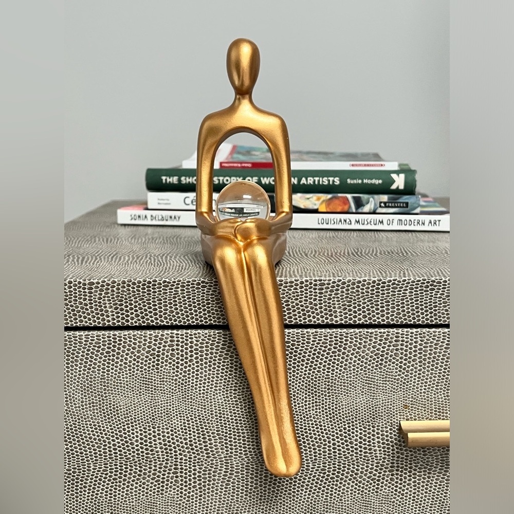 Brand New! Beautiful seated golden woman holding clear globe.